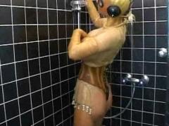 Huge Boobed Slut In Transparent Latex Catsuit Has A Shower And Rubs Her Pussy
