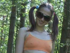 Pigtailed Babe In Dark Glasses Wees In Quiet Park
